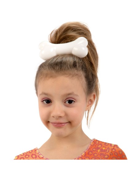 Molletta fermacapelli bianca a forma di osso indossata da bambina con capelli raccolti per costume preistorico